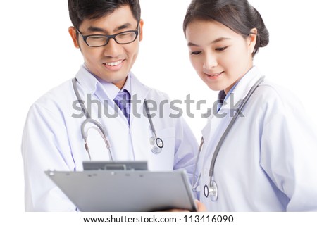[[stock_photo]]: Two Young Successful Clinicians In Uniform Looking Through Online Medical New