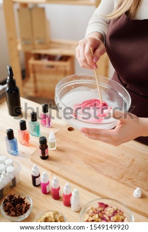 Сток-фото: Hands Of Craftswoman Mixing Liquid Soap Mass With Crimson Color In Glassware