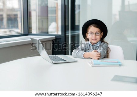 Stock fotó: Cute Diligent Schoolgirl In Casualwear And Eyeglasses Making Notes