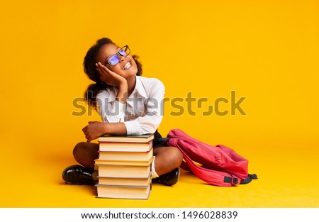 Stockfoto: Little Girl Sitting On A Stack Of Books
