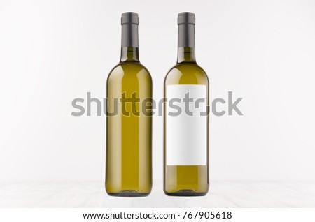 ストックフォト: Transparent Wine Bottle With White Wine On White Wooden Board Mock Up Vertical