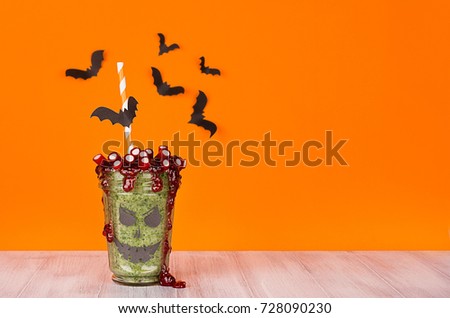 [[stock_photo]]: Halloween Treat Orange Background Fun Green Zombie Dessert With Bats Straw Candies