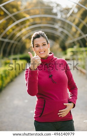 Stok fotoğraf: Motivated Pregnant Woman Doing Thumbs Up Success Gesture After Urban Workout At The Park On Early Au