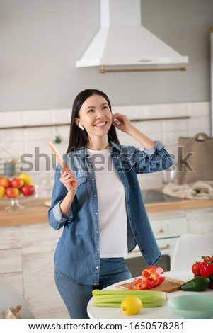 [[stock_photo]]: A Young Girl In The Headphones Stands Near The Table And Draws A Marker On A Magnetic Board