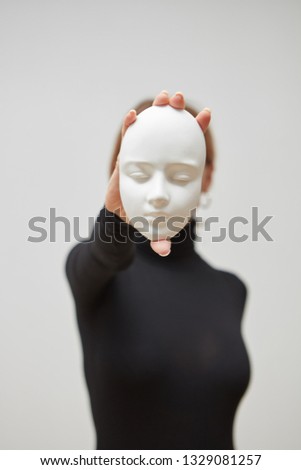 Foto stock: Womans Hands Hold Gypsum Mask Girl In A Black Jumper With Plaster Sculpture On A White Background