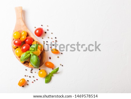 Stockfoto: Organic Mini Tomatoes With Basil And Pepper In Oilve Wood Plate On White Kitchen Background San Mar