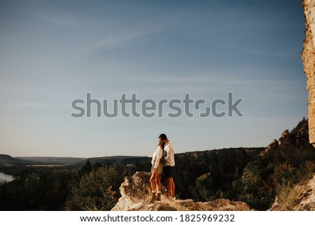 ストックフォト: A Young Strong Man Hugs His Beloved Woman On Top Of A Mountain With The Background Of Stone Mountain