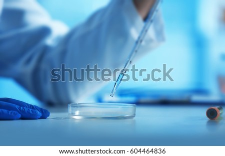 [[stock_photo]]: Scientist Dropping Liquid Substance Into Petri Dish With Biological Material
