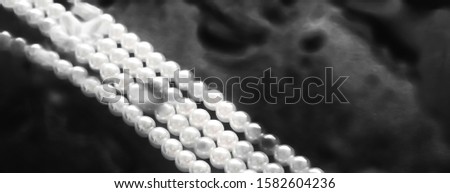 [[stock_photo]]: Coastal Jewellery Fashion Pearl Necklace Under Black Water Back