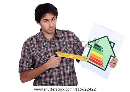 Stock foto: Craftsman Pointing At The Rate Of Energy Consumption Of A House