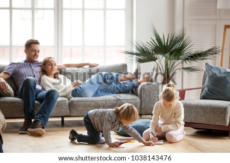 Foto d'archivio: Carefree Woman Sitting On The Couch In A Living Room And Leaning Back