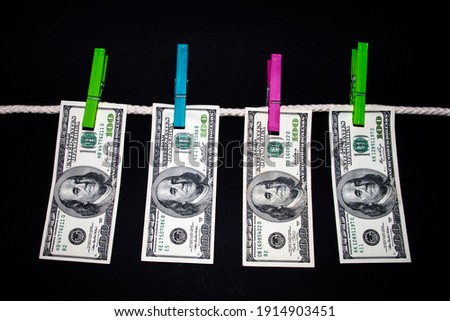 Stockfoto: Dirty Us Dollar Banknotes Hanging From A Clothesline And Reflect