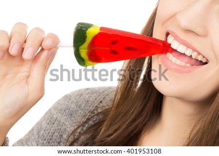 Foto d'archivio: Closeup Of Young Pretty Woman Biting Watermelon Shaped Lollypop