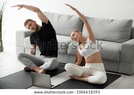 Stok fotoğraf: Two Concentrated Women Working Out And Stretching In Yoga Center