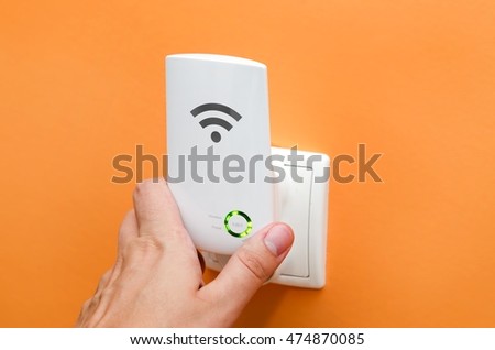 Stockfoto: Wifi Repeater In Electrical Socket Simply Way To Extend Wireles