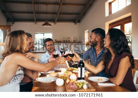 Zdjęcia stock: Group Of Friends Toasting Glasses Of Wine During Meal