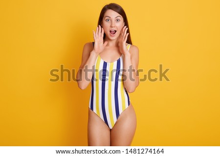 Сток-фото: Suprised Woman In Swimwear Posing Isolated Over Pink Wall Background Looking Aside With Mouth Opened