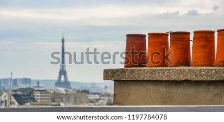 Stok fotoğraf: The Roofs Of Paris And Its Chimneys Under A Clouds Sky