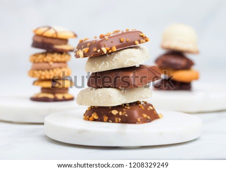 Foto stock: Luxury Belgian Chocolate And Biscuit Cookies Selection On Marble Coasters And White Kitchen Table Ba