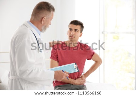 Foto stock: Mature Patient With Health Problems And Doctor In Medical Center
