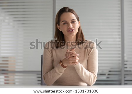 Foto stock: One Of Young Businesswomen Making Presentation Or Helping Colleague