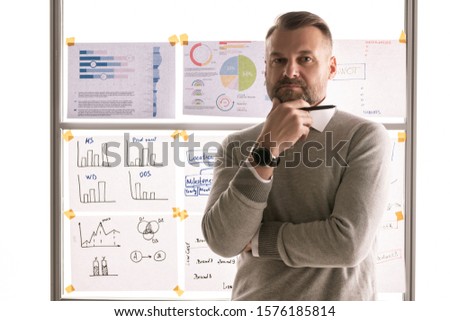 ストックフォト: Serious Mature Businessman In Pullover Standing Against Whiteboard