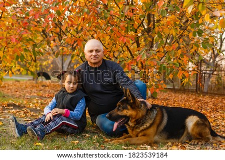 [[stock_photo]]: Grandfather With Granddaughter In Wood In Autumn Look On Ducks In Water