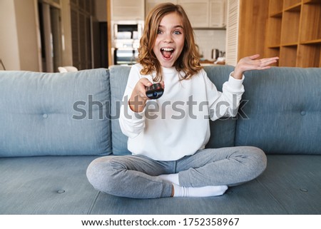 [[stock_photo]]: Young Blonde With Remote Control