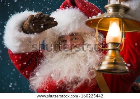 Сток-фото: Santa Claus Is Holding A Shining Lantern While Sneaking To His H
