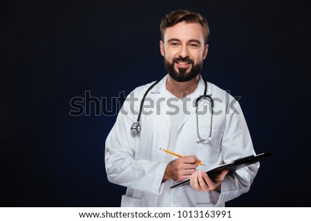 Stock photo: Portrait Of A Smiling Male Doctor Holding A Notepad And Finger U