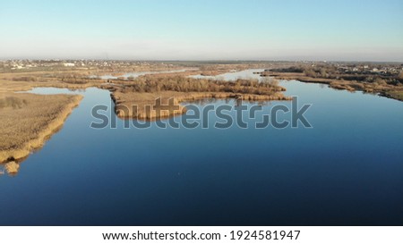 Foto stock: Small Village In The Distance With The Creek And Marsh In Front