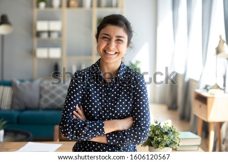 Stok fotoğraf: Lifestyle People Concept Young Pretty Smiling Indian Girl With Long Nails Wearing Lot Of Jewelry Ri