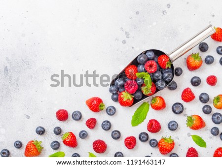 Foto stock: Fresh Raw Organic Berries In Steel Scoop Spoon On Kitchen Table Backgroundtop View Strawberry Ras