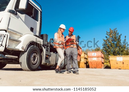 [[stock_photo]]: Worker Signing Papers To Have Delivered Demolition Rubble Container