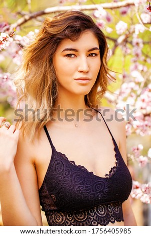 ストックフォト: Beautiful Girl Posing In The Pink Peach And Sakura Flowers Blooming Garden Young Attractive Woman S