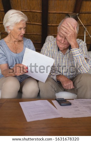 Zdjęcia stock: Front View Of A Senior Couple Looking And Discussing Over Medical Bills In Living Room At Home