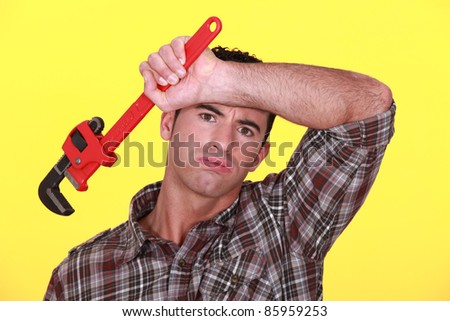 Stock fotó: Exhausted Craftsman With Adjustable Spanner Against Yellow Background