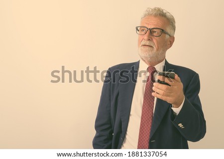 Stok fotoğraf: Businessman Looking Up While On The Phone Against A White Background