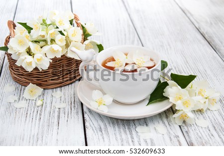Glass Cup Of Green Tea With Jasmine Flowers Isolated On White Foto stock © almaje