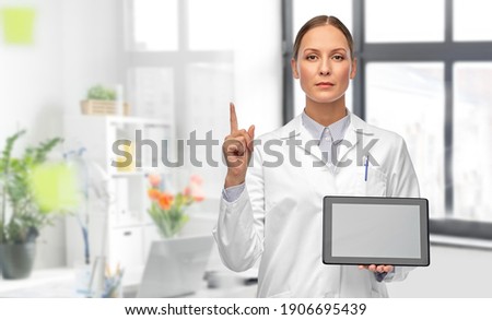 Zdjęcia stock: Female Doctor Finger Pointing To Blank Tablet Computer Screen Di