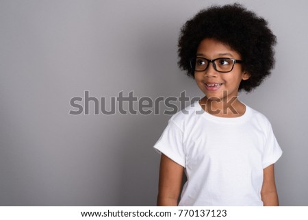 Stok fotoğraf: Pretty Cute Little Girl In White Shirt Glasses And Black Trousers Hold Red Paper Folder