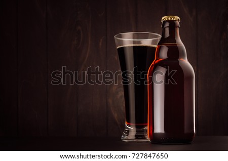 Foto stock: Brown Beer Bottle Belgian Steinie And Glass Pilsner With Porter On Dark Wood Board Vertical Mock U