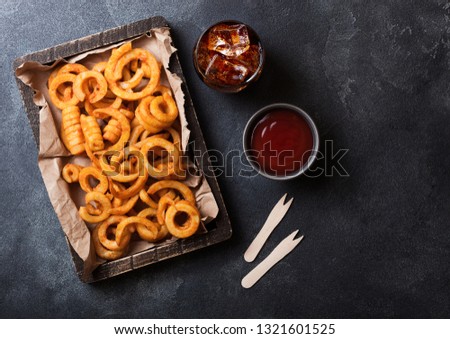 Stock foto: Curly Fries Fast Food Snack In Red Plastic Tray With Glass Of Cola And Ketchup On Stone Kitchen Back