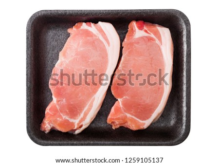 ストックフォト: Raw Pork Loin Chops In Plastic Tray With Knife And Fork On Rusty Background Salt And Pepper With Fr