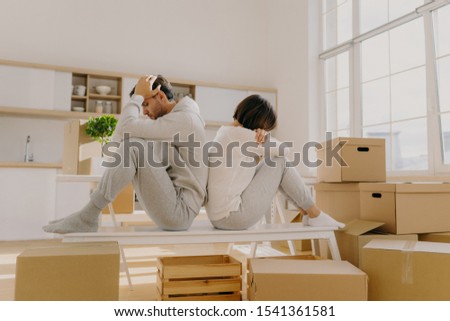 Stockfoto: Photo Of Stressful Couple Get Divorse Leave House Start Living Seperately Sit Backs To Each Other