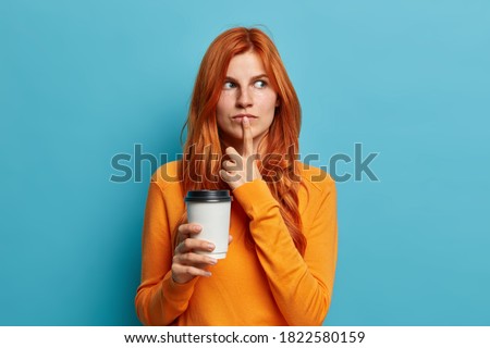 Zdjęcia stock: Photo Of Thoughtful Female Model Wears Red Sweater Drinks Tea Has Dark Hair Contemplates About So