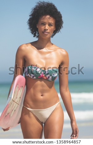 Stok fotoğraf: Portrait Of Beautiful Mixed Race Female Surfer With A Surfboard Sitting On A Beach On A Sunny Day S