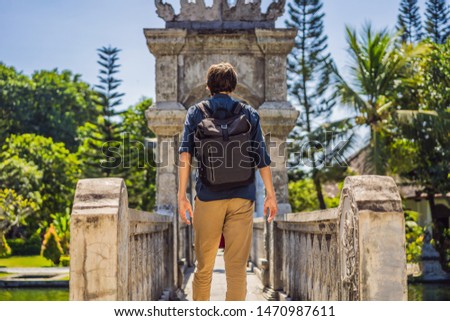 Foto stock: Young Man In Water Palace Soekasada Taman Ujung Ruins On Bali Island In Indonesia Amazing Old Archi