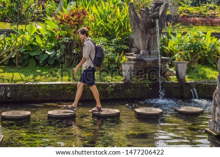 Stock fotó: Young Man Tourist In Taman Tirtagangga Water Palace Water Park Bali Indonesia