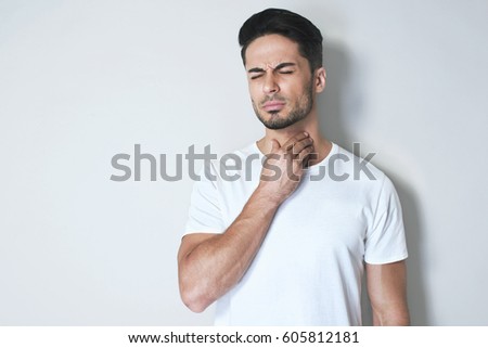 Stock foto: Young Asian Man Having Sore Throat And Touching His Neck With Wearing Medical Mask